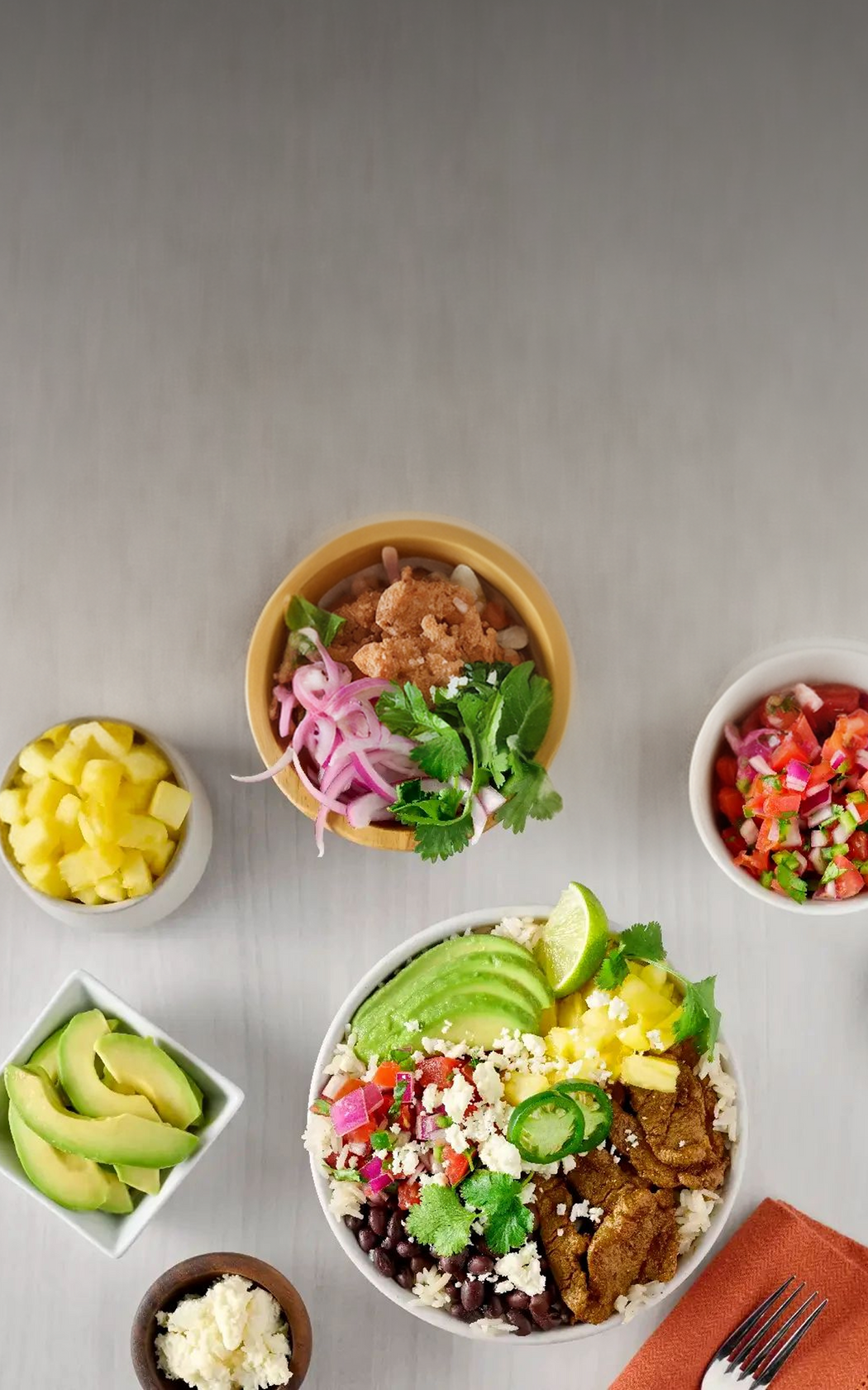 Colorful salad bowl with various ingredients on a gray surface