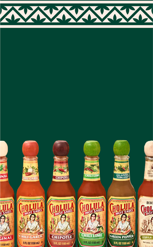 Row of Cholula hot sauce bottles on a green background