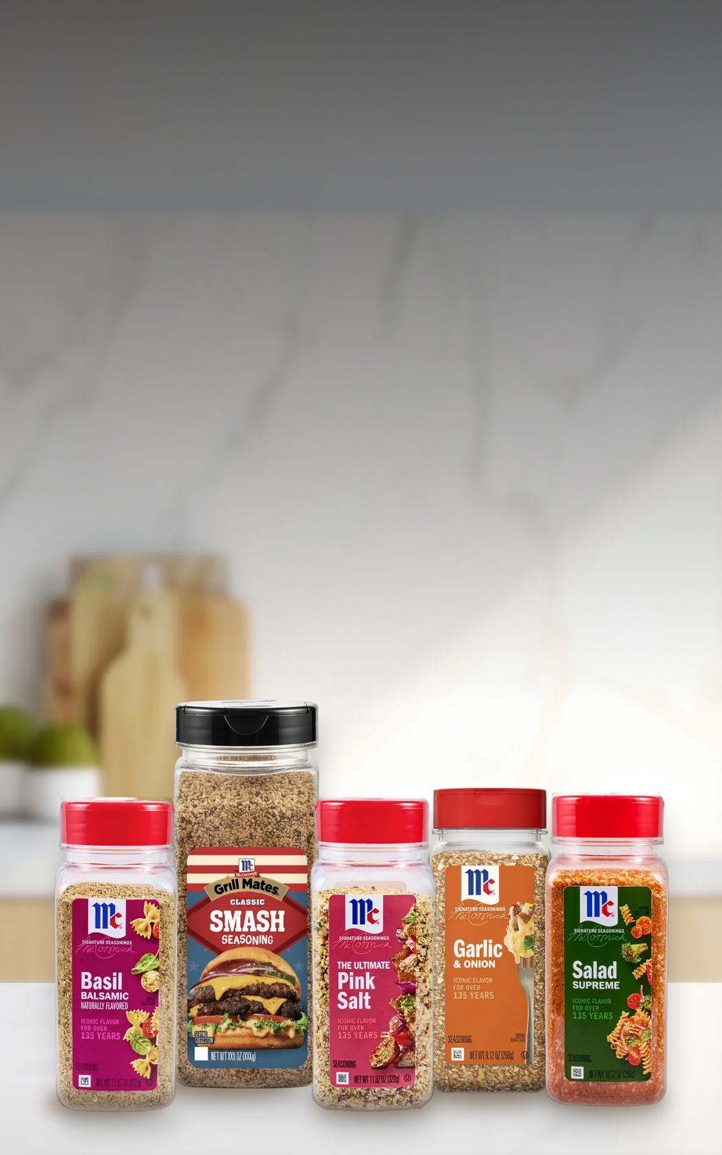 Collection of McCormick seasoning bottles on a kitchen counter with a blurred background.