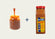 A jar of caramel and a bottle of Old Bay seasoning with a plus sign between them on a light background.