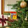 A festive Christmas tree is decorated with a unique ornament shaped like a yellow tin of Old Bay Seasoning hanging among gold baubles and lights.