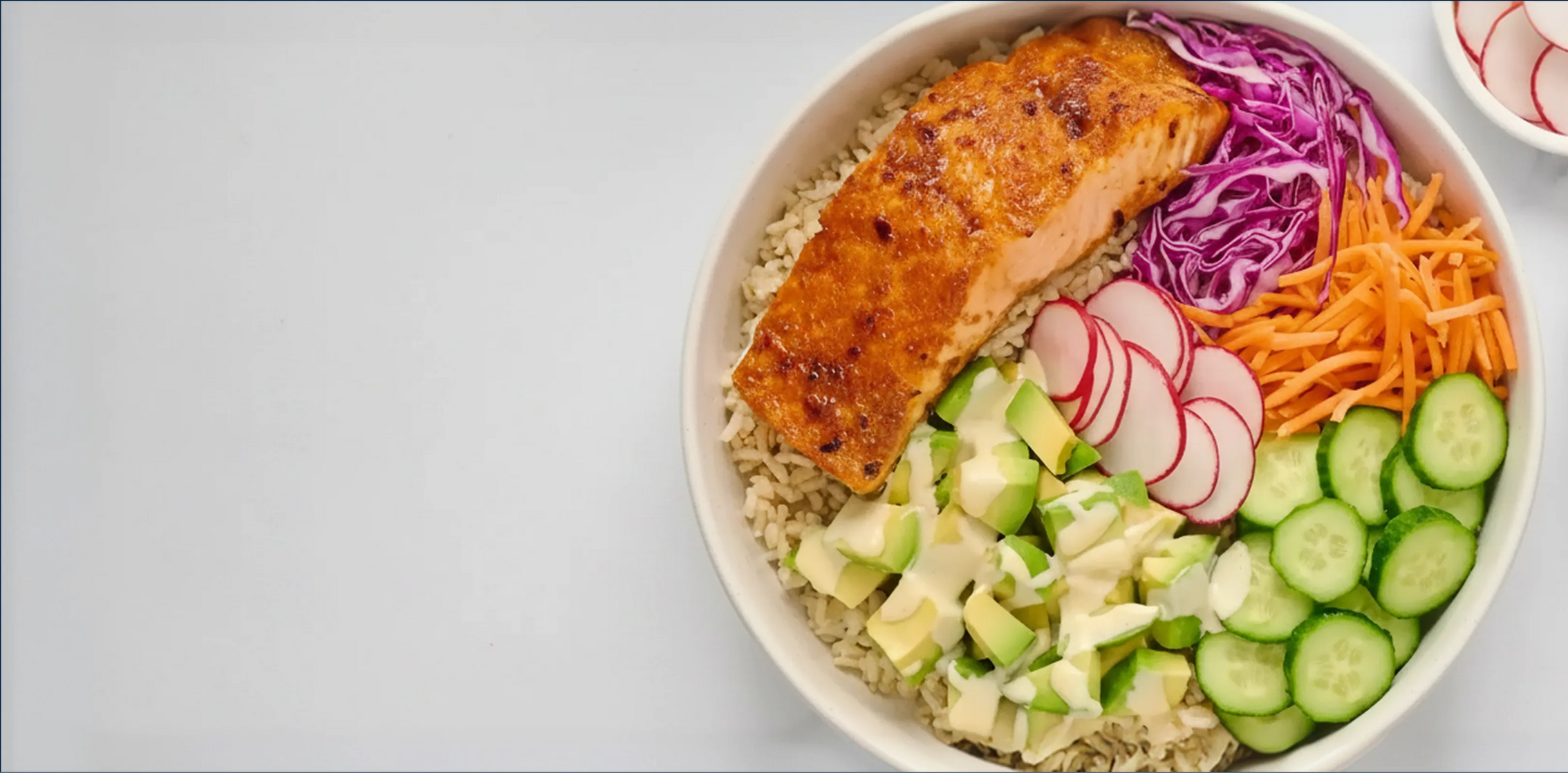 Salmon bowl with various vegetables on a gray background
