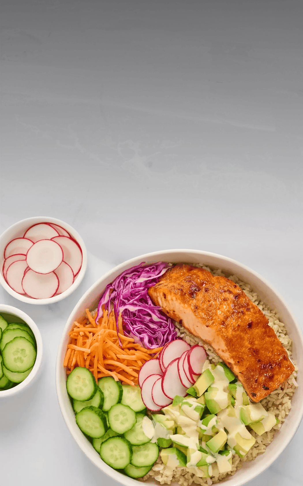 Salmon bowl with vegetables on a gray background