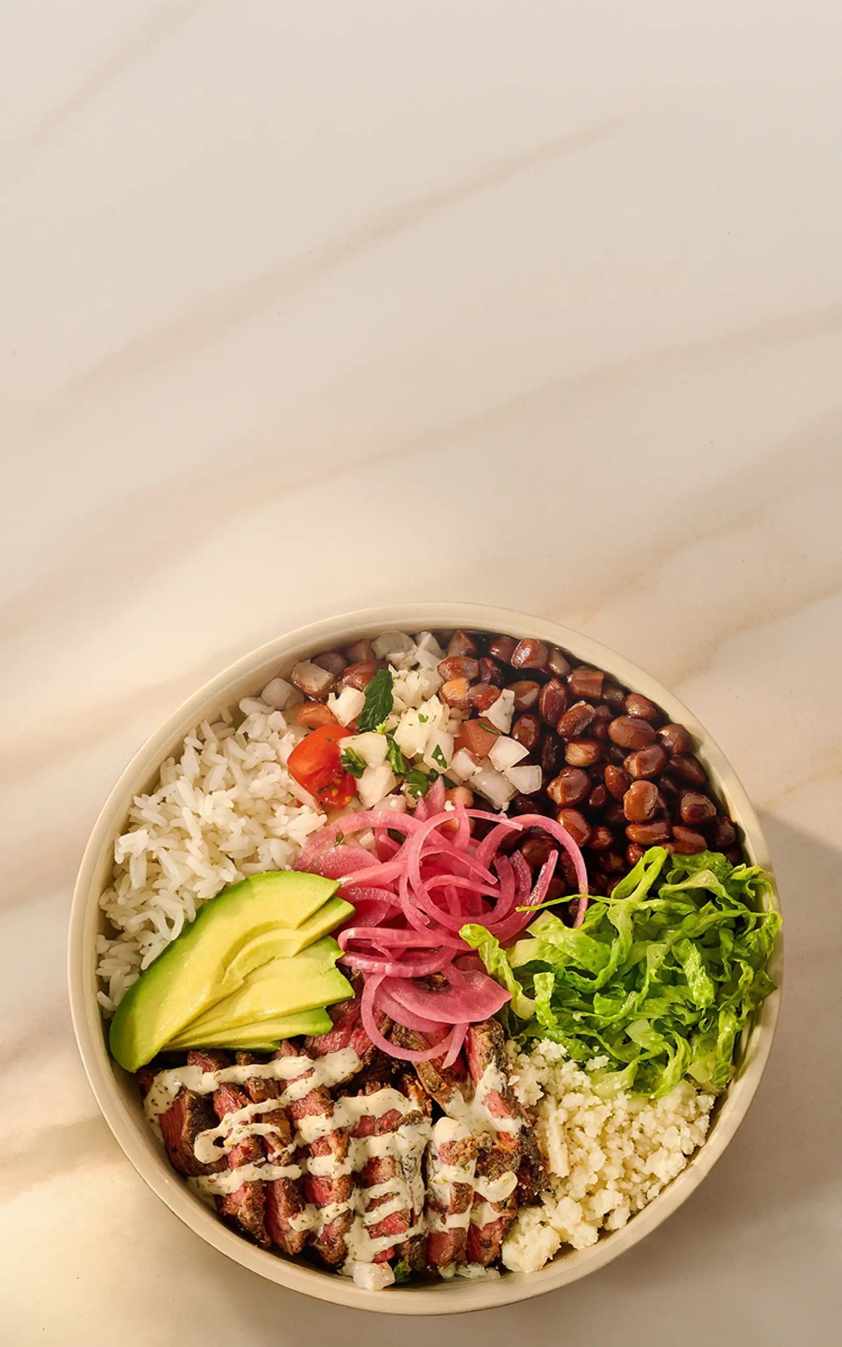 Colorful salad bowl with various ingredients on a light background