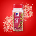 Bottle of pink salt with a red label on a red background