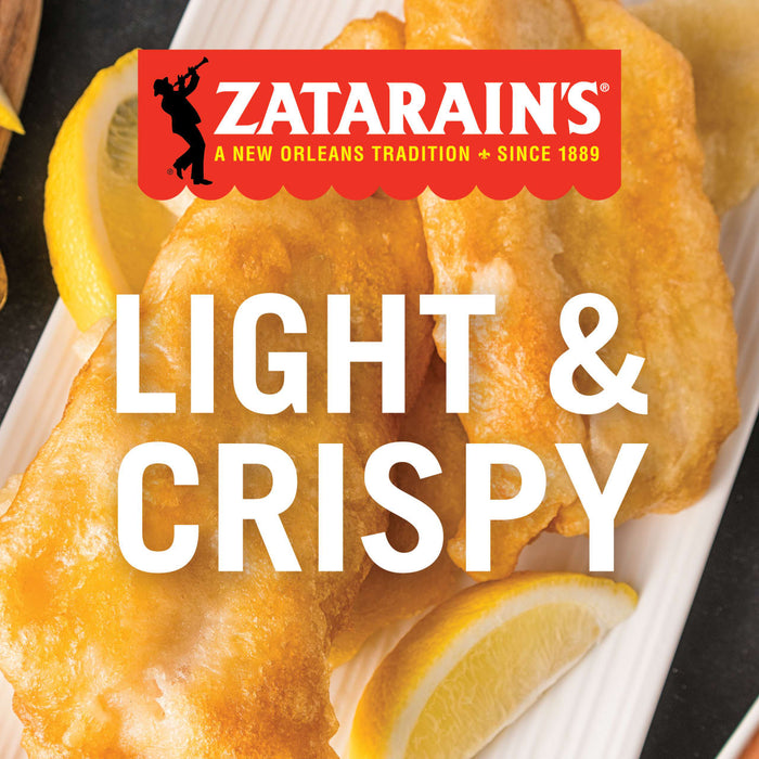 Zatarains Light &amp; Crispy fish fillets on a white plate with lemon wedges.