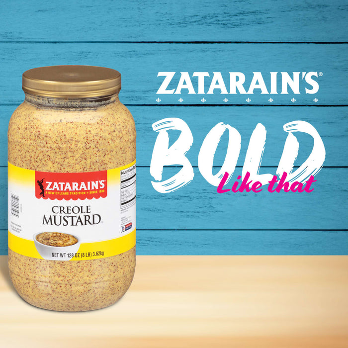 A jar of Zatarain\s Creole Mustard on a blue and beige wood background with the text BOLD like that above it.