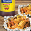 A close-up of a foil packet of Zatarains Shrimp &amp; Crab Boil with corn on the cob, shrimp, sausage, and potatoes.