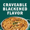 A bowl of rice with chicken and a creamy sauce, with the text Craveable Blackened Flavor above it.