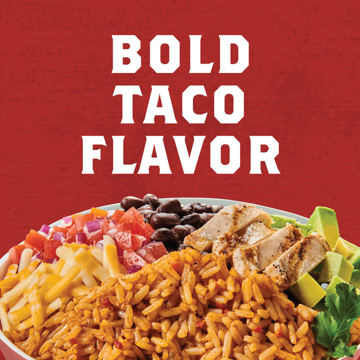 A bowl of rice, black beans, chicken, avocado, cheese, tomato, and red onion with the text BOLD TACO FLAVOR above it.