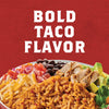 A bowl of rice, black beans, chicken, avocado, cheese, tomato, and red onion with the text BOLD TACO FLAVOR above it.