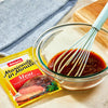 A bowl of Adolphs Marinade in Minute Meat Tenderizing Marinade Mix with a whisk.