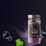 Jar of black currant sugar with black currants and a leaf on a dark background