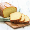 A loaf of bread sliced on a wooden cutting board.