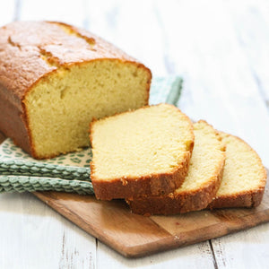 A loaf of bread sliced on a wooden cutting board.