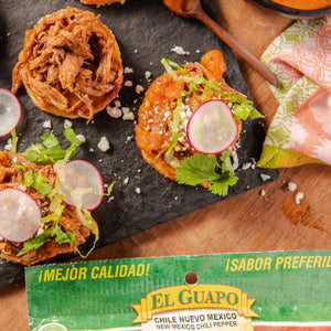 A close-up of El Guapo Chile Nuevo Mexico chili peppers with a tagline that says, ¡MEJOR CALIDAD! ¡SABOR PREFERIDO!