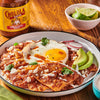 A plate of Cholula Original Medium salsa with a fried egg, avocado, and radish.