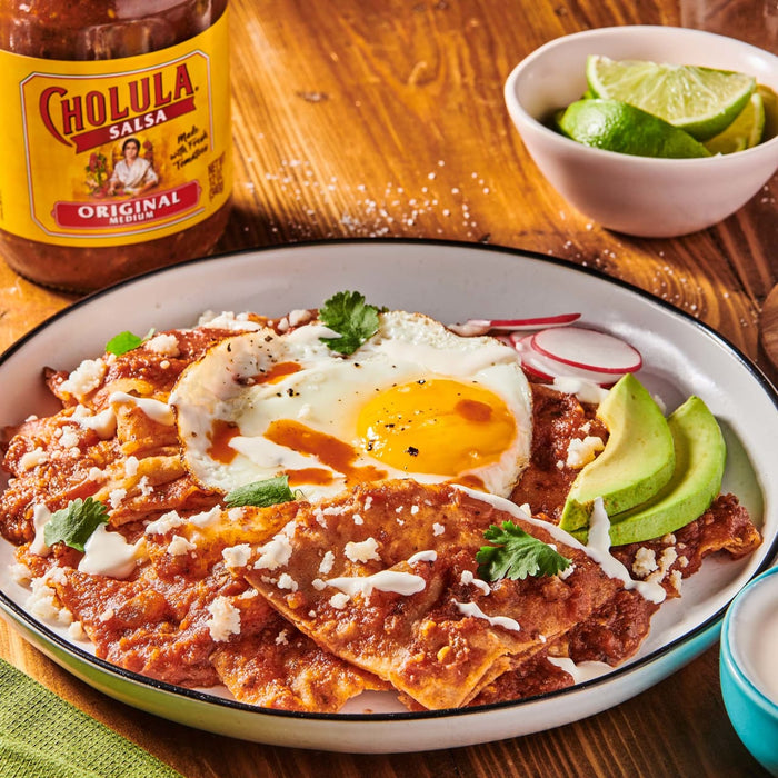 A plate of Cholula Original Medium salsa with a fried egg, avocado, and radish.