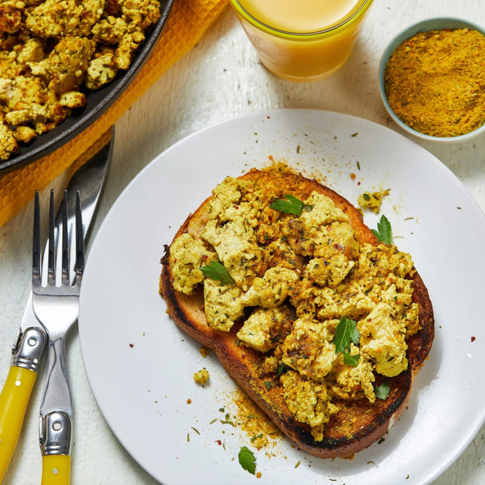 A plate of toast topped with scrambled tofu and spices.