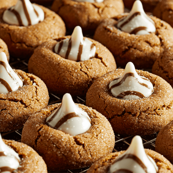 Close up of gingerbread cookies topped with chocolate kisses.