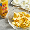 A bowl of chopped hard-boiled eggs with a dollop of Frenchs Creamy Yellow Mustard Spread.