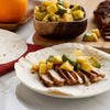 A tortilla filled with grilled chicken, mango, and avocado.