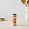 A bottle of McCormick Himalayan Pink Salt stands on a kitchen counter.