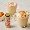 Two mugs of pumpkin spice lattes with McCormick Pumpkin Spice seasoning and pumpkin puree are displayed.