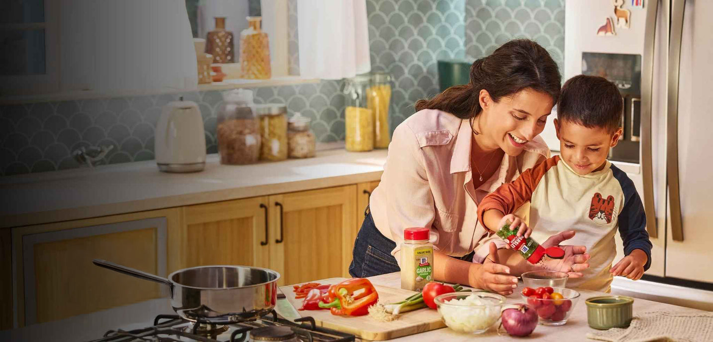 Woman and child in a kitchen preparing food together
