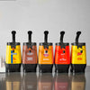 Five different condiment bottles from Old Bay, Cattlemens, RedHot, Frenchs and Frenchs are lined up on a table.