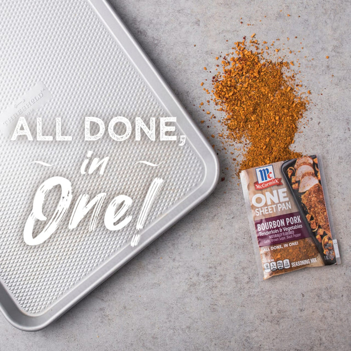 A McCormick One Sheet Pan Bourbon Pork seasoning packet with a baking sheet and spilled seasoning.