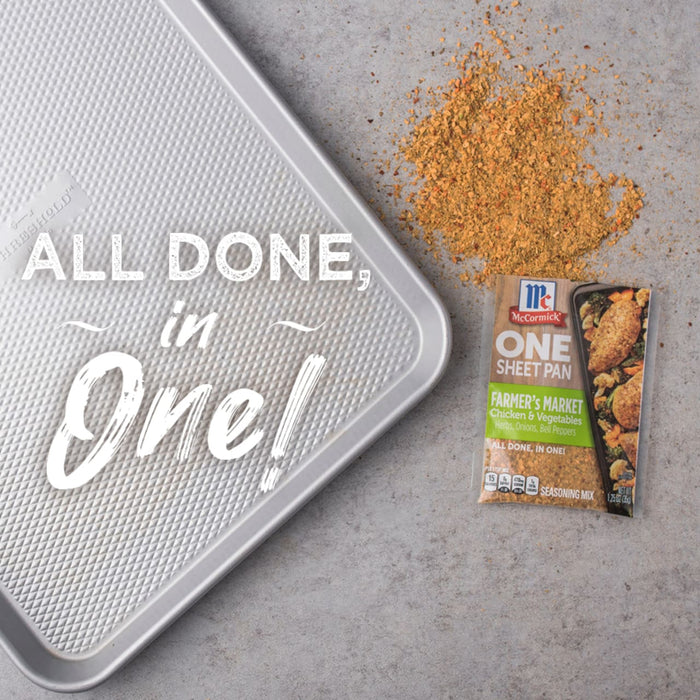 A McCormick One Sheet Pan seasoning packet with a baking sheet and a pile of seasoning.