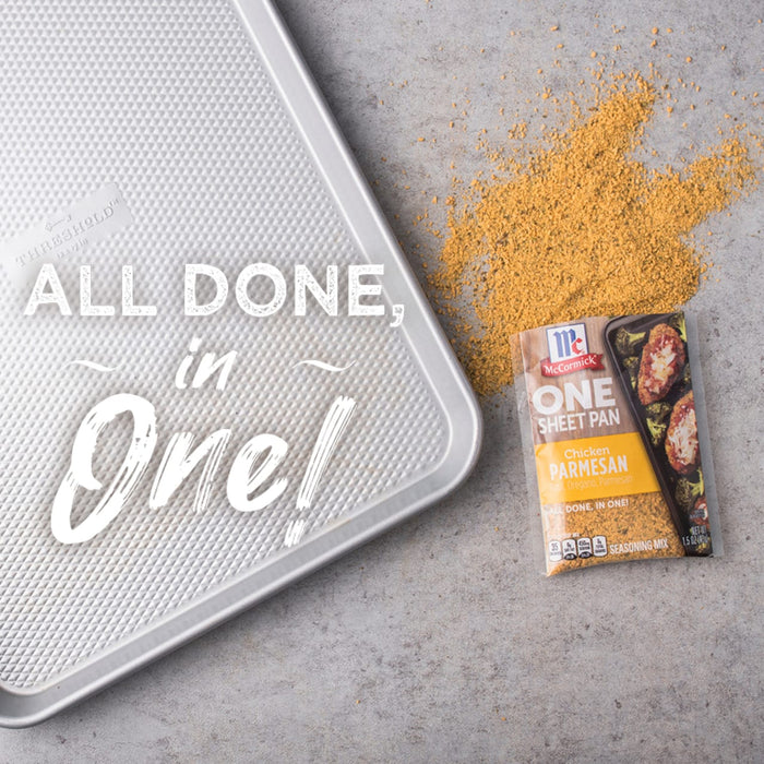 A McCormick One Sheet Pan Chicken Parmesan seasoning packet with a baking sheet and seasoning on a grey background.