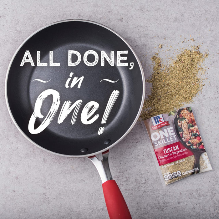A black skillet with the words All Done in One! written in white on it next to a McCormick One Skillet Tuscan Chicken &amp; Vegetables seasoning packet
