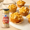 A group of muffins with a McCormick Salted Caramel seasoning bottle in the foreground.