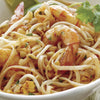 A close up of a bowl of Pad Thai noodles with shrimp.
