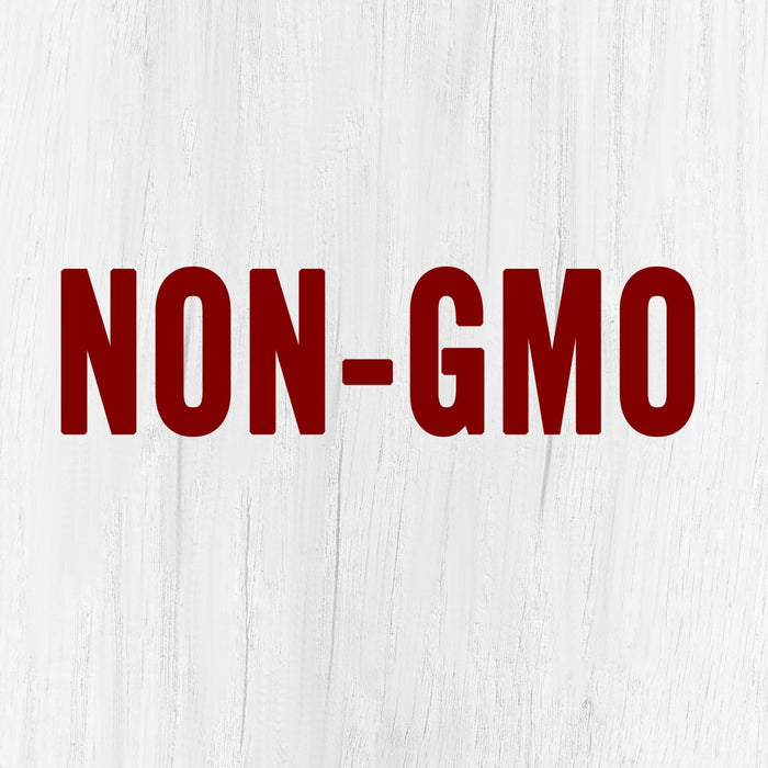 The words NON-GMO in red letters on a white wooden background.