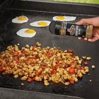 sprinkling seasoning on good on a grill