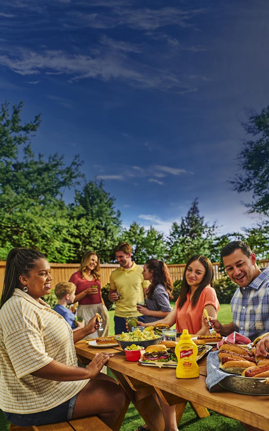 gathering outside at picnic table with frenchs