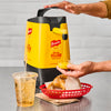 A hand pours Frenchs Classic Yellow Mustard into a small container.