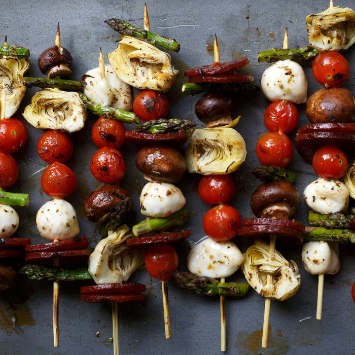 Grilled skewers with artichoke, mozzarella, cherry tomatoes, asparagus, and mushrooms.