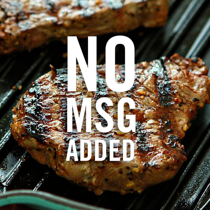 Two grilled steaks on a black grill with the text NO MSG ADDED in white.