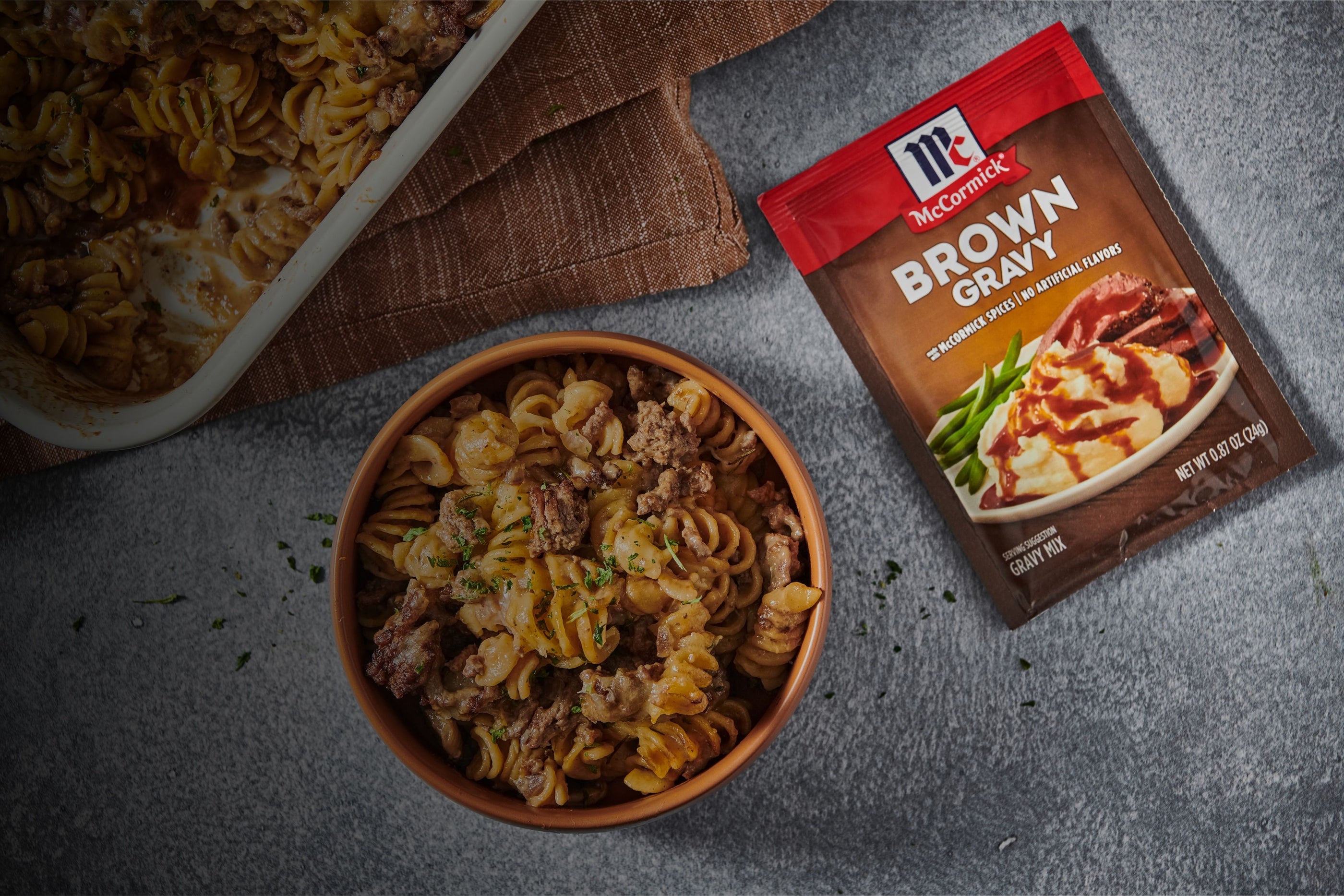 brown gravy mix with a bowl of macaroni and ground beef dish