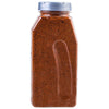 A plastic bottle filled with a red spice blend.