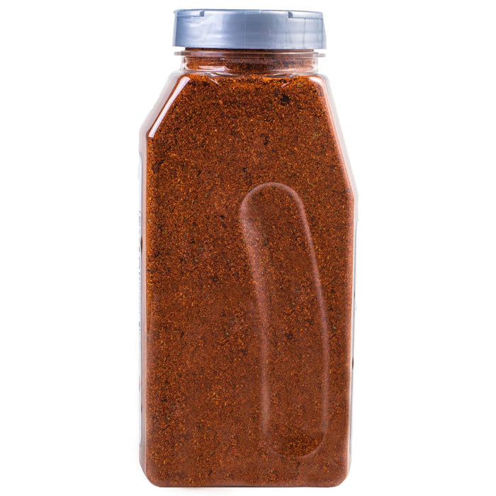 A plastic bottle filled with a red spice blend.