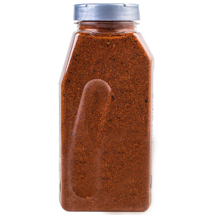 A plastic bottle filled with a red spice blend.