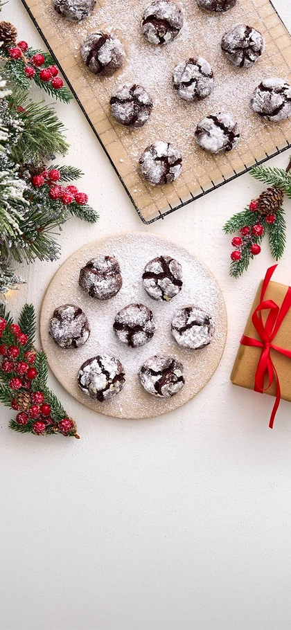 Christmas cookies on a plate with festive decorations and a gift box.