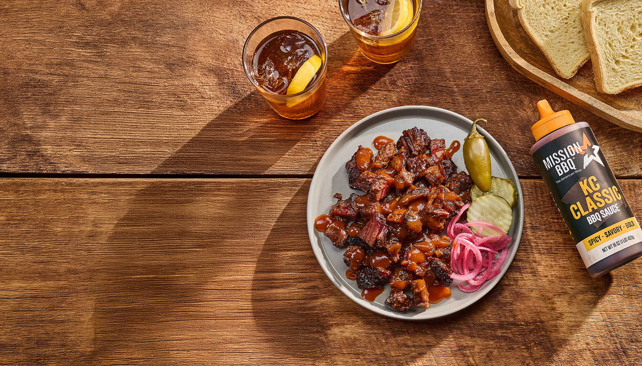 burnt ends on a table with KC classic sauce