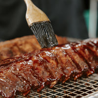 layering sauce on ribs