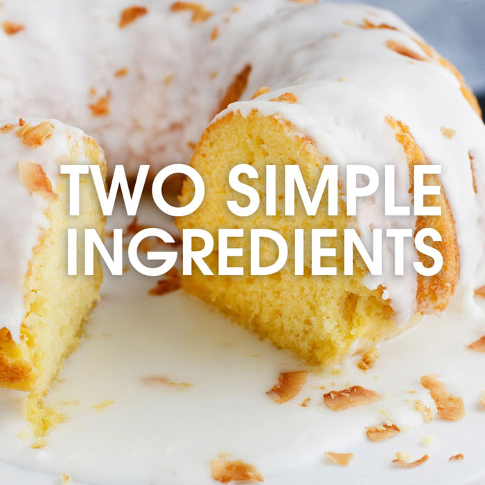 A close-up of a coconut cake with a white glaze and the text Two Simple Ingredients on top.